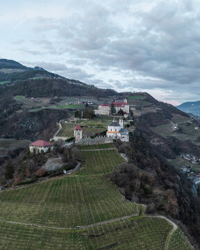 Aerial view of Sabiona Monastery and Chiusa town with beautiful castle, Klausen, South Tyrol, Italy.