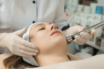 Obraz na płótnie Canvas Electroporation procedure close-up. Girl on a cosmetic procedure
