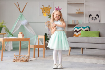 Cute little girl dressed as fairy at home