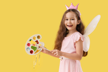 Cute little fairy with wand and paint palette on yellow background