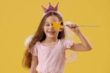 Cute little fairy with wand on yellow background