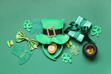 Leprechaun hat with gift box, bow tie and decor on green background. St. Patrick's Day celebration