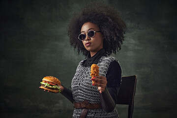 Fast food ads. African woman, medieval warrior in chainmail, sunglasses, holding burger and chicken...
