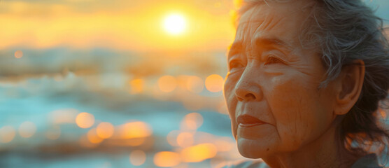Thoughtful, elderly Asian and woman with sunset, female and mental health on beach. Retirement, depressed and looking. Background views for reflecting and reminiscing about past days