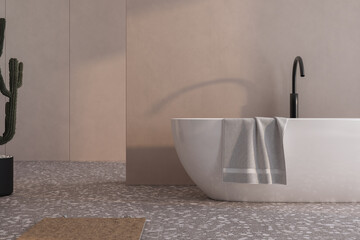 A white bathtub with a towel draped over it sits in front of a wall. The towel is folded neatly and...