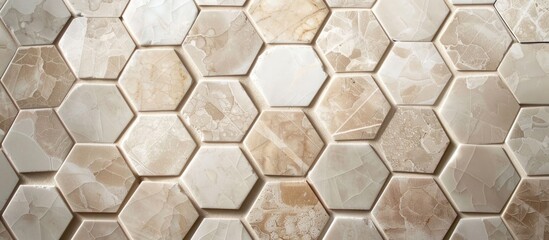 A close up of a hexagon tile pattern on a wall showcasing a symmetrical design with brown, white,...