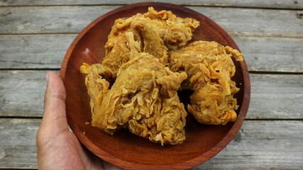 crispy kentucky fried chicken in a wooden table. Isolated on Grey background.