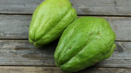 Fresh chayote fruits (Sechium edulis) on wooden background