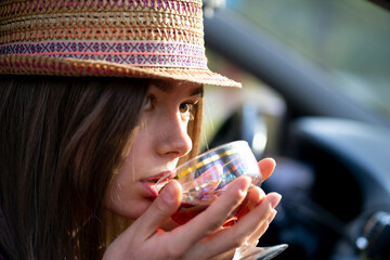 The girl raised a glass of wine to her lips