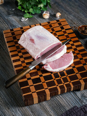 Large pieces of chopped pork meat on a beautiful wooden board.