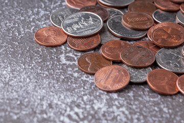 American coins and US dollars on a wooden table