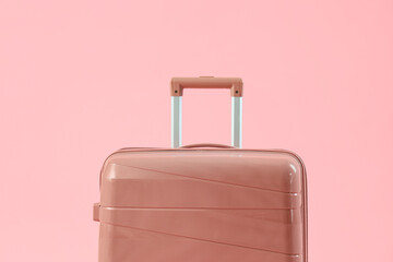 Big suitcase on pink background, closeup