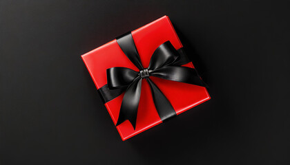 Black Friday concept. Banner with gift box wrapped in red paper and tied with black bow on black background, top view. Copy space.