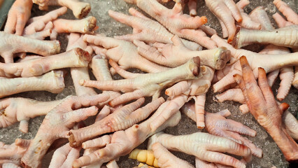 Fresh raw chicken feet displayed on ice at a Banjar City supermarket, Indonesia.