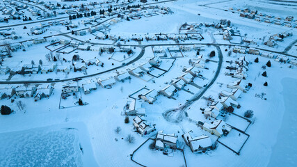 Aerial Snow-Blanketed Suburban Neighborhood in Winter Tranquility