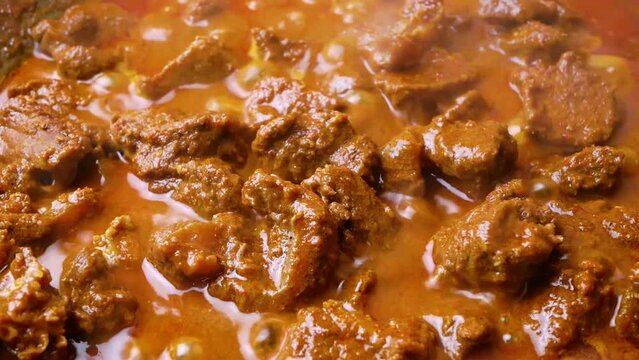 Close-up of beef rendang in the making, a popular traditional indonesian dish. Selective focus