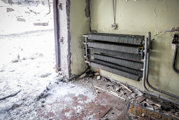 Old heating radiator in destroyed ruined building after being hit by a Rashist missile in Ukraine
