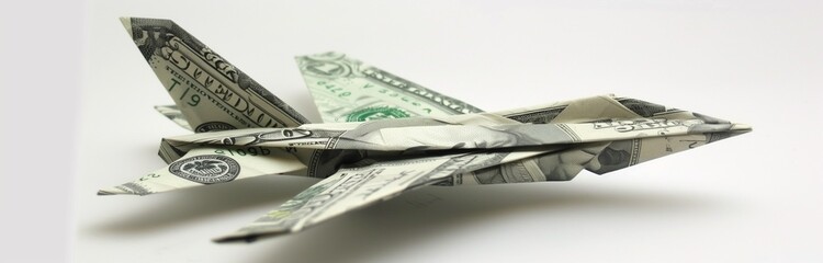 small origami paper plane made out of banknotes 