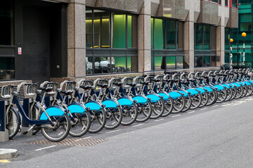 Bicycles for rent on the street in the city center. Row of city bikes for rent in London, UK - 763320392
