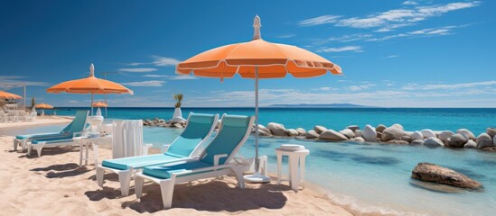 Fototapeta premium swimming pool and loungers umbrellas near beach