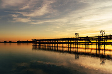 Fototapeta na wymiar Sunset at The Rio Tinto Pier (Muelle de Rio Tinto) in Huelva, Andalusia, Spain