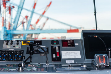 View of the control console on the navigational bridge of the cargo container ship. 