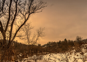 Winter views of the Poprad Landscape Park on the Poprad River in the Beskid Sadecki mountains.