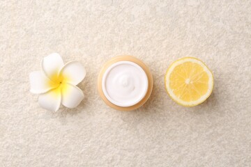Body care. Moisturizing cream, sea salt and flower on light textured table, flat lay