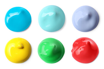 Paint blobs of different colors on white background, top view