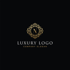 Luxurious elegant victorian floral filigree frame badge pattern with Initial letters N inside  circle badge emblem logo design vector in gold colors