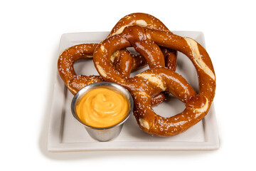 Large pretzels with nustard sauce on a white plate