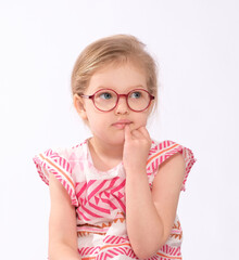 Thoughtful little girl with glasses