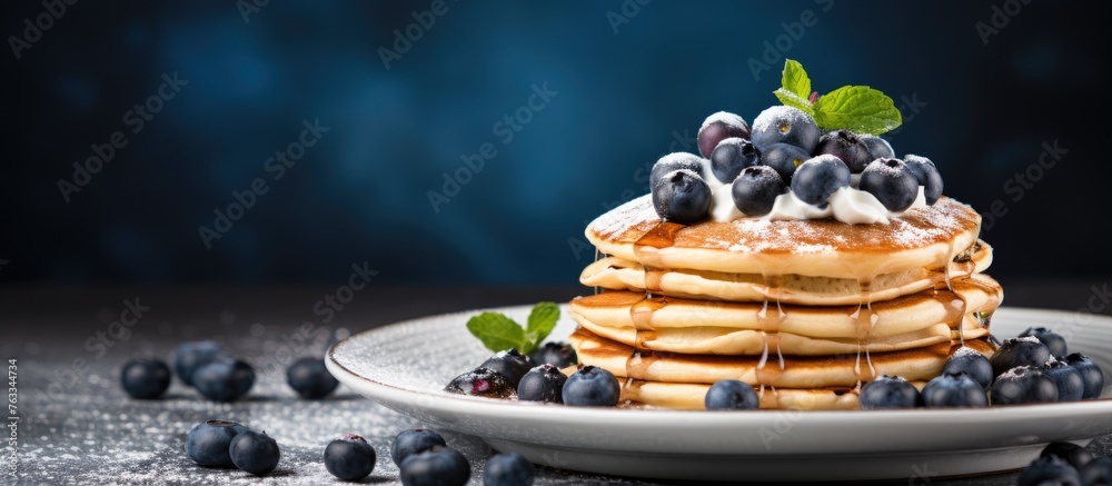 Wall mural A plate of pancakes topped with blueberries and syrup