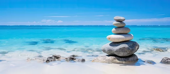 Foto op Aluminium A stack of rocks on a beach by the sea © Ilgun