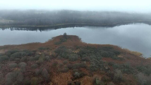 Morning fog over lake in rural, Aerial drone view. Wildlife landscape in autumn. Morning mist haze over farm field. Nature at dawn in fog. Morning scene in misty forest valley. Rural in Morning fog