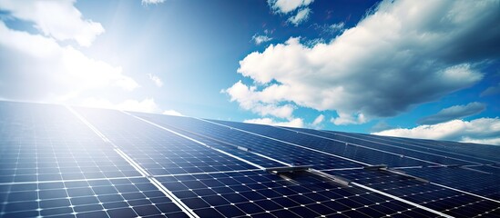 Solar panels on a rooftop under a blue sky with clouds