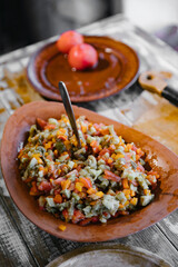 A large bowl of vegetable salad. Mottled cubes of vegetables, finely chopped. Healthy eating concept.