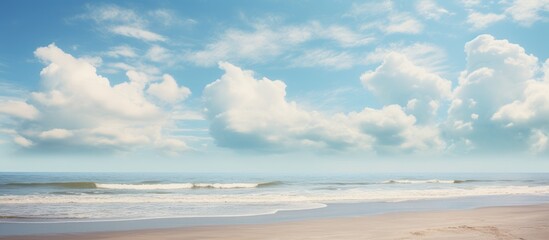 Fototapeta premium A man strolling on the shore holding a surfboard