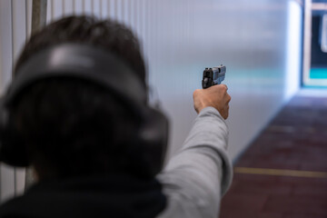 Man Shooting with a Gun in Shooting Range with Target in Switzerland.