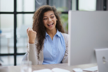 Emotional girl surprised with getting victory in online contest reading news from laptop computer