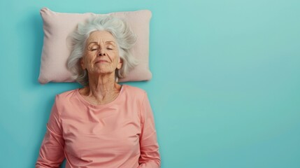 Elderly woman sleeping on pillow isolated on pastel blue colored background Sleep deeply peacefully rest. Top above high angle view photo portrait of satisfied .senior wear pink shirt