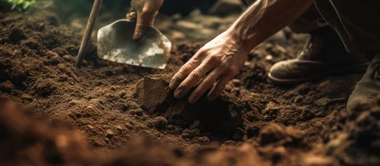 Foto op Canvas Person using shovel to dig hole in ground © vxnaghiyev