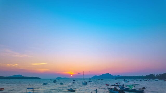 Time lapse amazing pink sky in Dramatic Sunset..dramatic sky with colorful pink cloudscape.amazing pink sunset Gradient color colorful sky in bright sunset background. .Rawai fishing boat mooring..