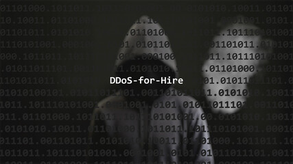 Cyber attack ddos-for-hire text in foreground screen, anonymous hacker hidden with hoodie in the blurred background. Vulnerability text in binary system code on editor program.