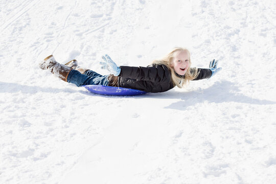 Girl Sledding in Winter
