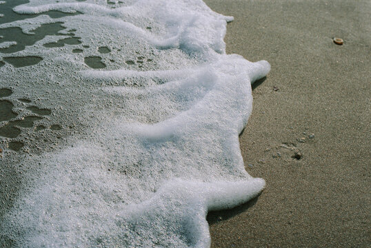 Sea foam in the sand; Topsail Island, North Carolina, United States of America
