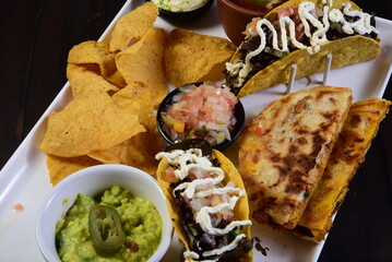 delicious Mexican cuisine guacamole, taco, tortilla, spicy Mexican chille