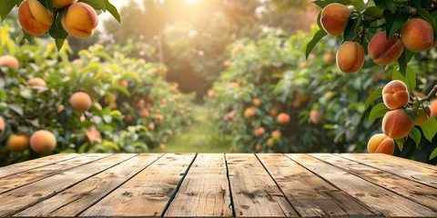 Tuinposter Empty wooden kitchen table over peach fruit garden background © Ricardo Costa