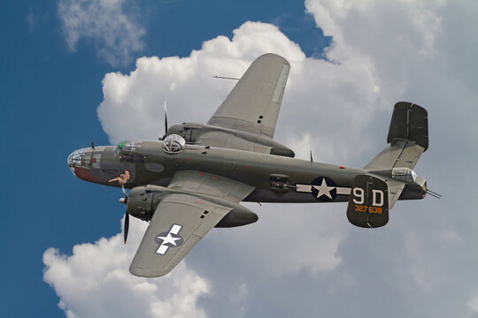 B-25 Mitchell Bomber in Flight with White, Puffy Clouds