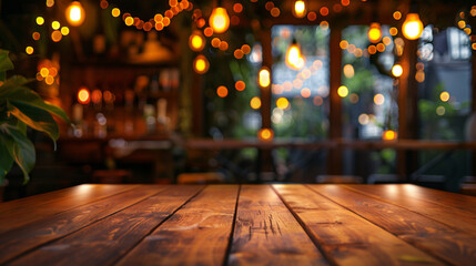 An empty wooden table with a soft glow of lights bokeh set against the blurred ambiance of a cozy restaurant background - obrazy, fototapety, plakaty